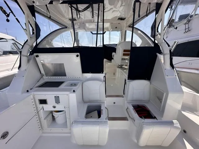 Slide: The Image of 2022 Pursuit OS 355 boat interior with seating, storage, and helm station. - 6