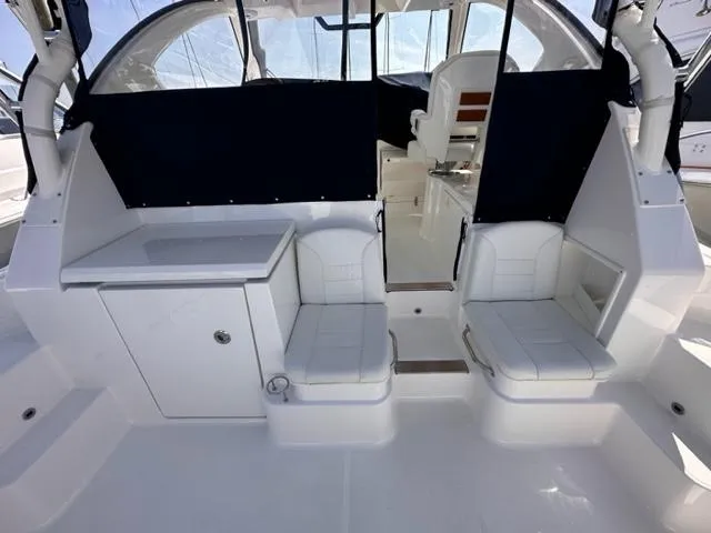 Slide: The Image of 2022 Pursuit OS 355 boat interior with seating and storage. - 7