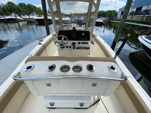 Slide: The Image of 2020 Scout 235 XSF boat interior at marina, showing helm and control panel. - 13