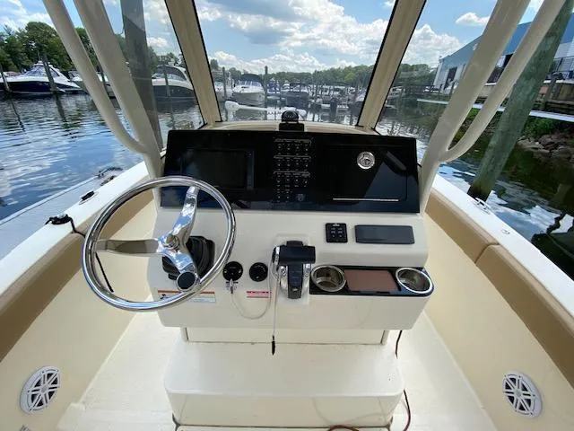 Slide: The Image of 2020 Scout 235 XSF boat helm with steering wheel and control panel. - 16