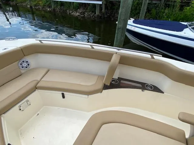 Slide: The Image of 2020 Scout 235 XSF boat interior with tan seating and cup holders. - 22