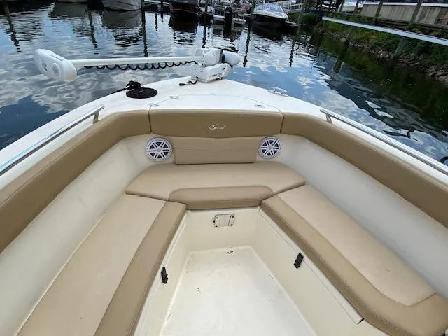 Slide: The Image of 2020 Scout 235 XSF boat interior with cushioned seating and speakers. - 23