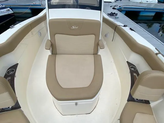 Slide: The Image of 2020 Scout 235 XSF boat interior with tan seating and cup holders. - 25