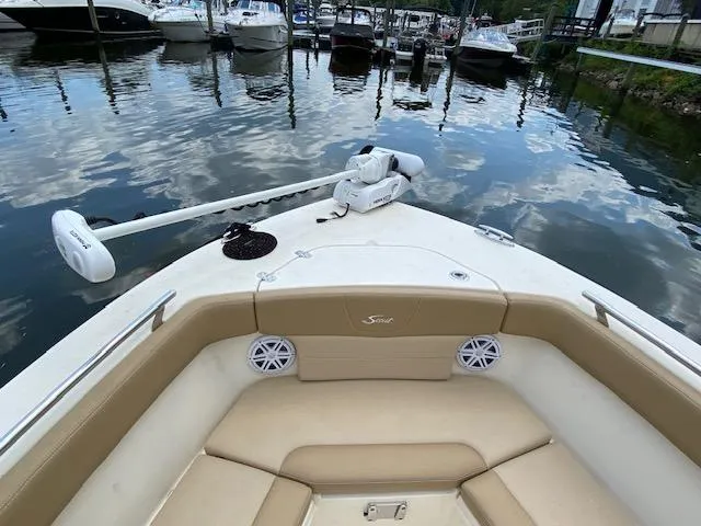 Slide: The Image of 2020 Scout 235 XSF boat bow with seating and trolling motor at marina. - 26