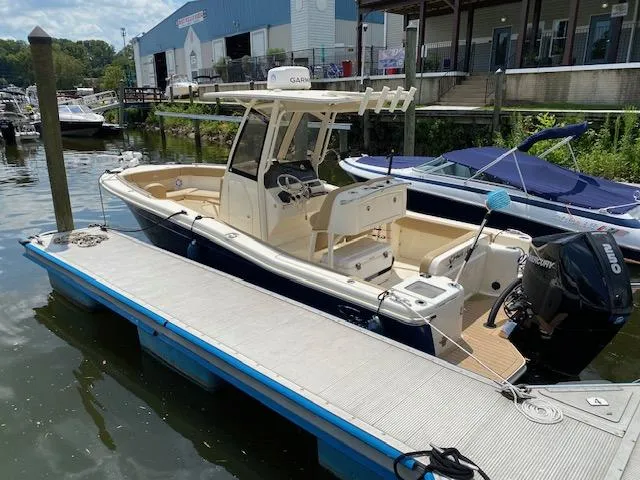Slide: The Image of 2020 Scout 235 XSF boat docked at a marina. - 6