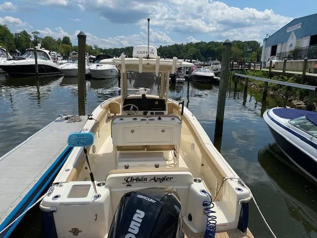 Slide: The Image of 2020 Scout 235 XSF boat docked at a marina, featuring a Mercury engine. - 8