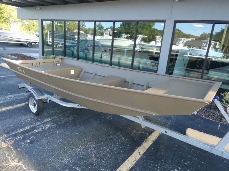 Slide: The Image of 2024 G3 1442 boat on trailer outside dealership. - 2