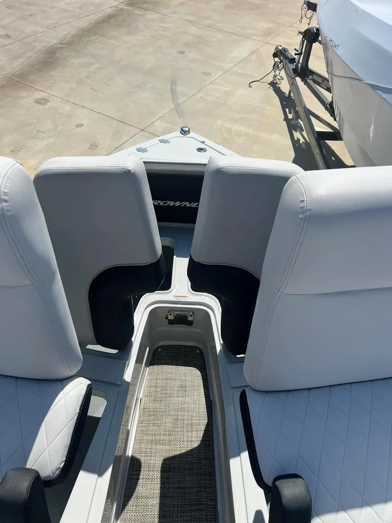 Slide: The Image of 2024 Crownline 260SS boat interior with white seating and deck view. - 10