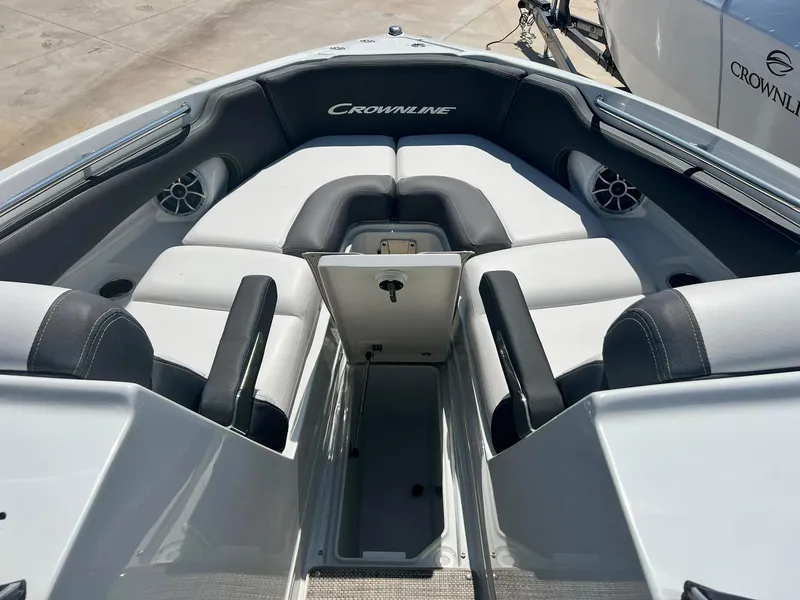 Slide: The Image of 2024 Crownline 260SS boat interior with cushioned seating and storage compartment. - 17