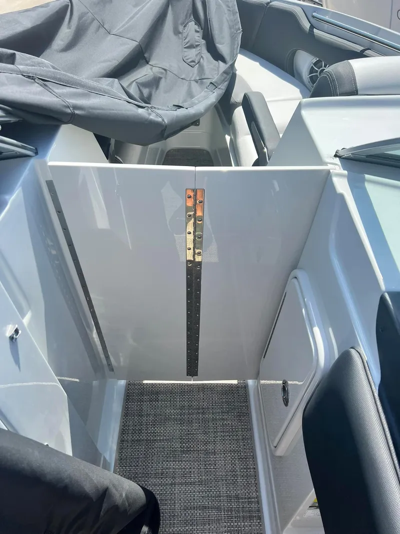 Slide: The Image of 2024 Crownline 260SS boat interior with seating and storage compartments. - 8