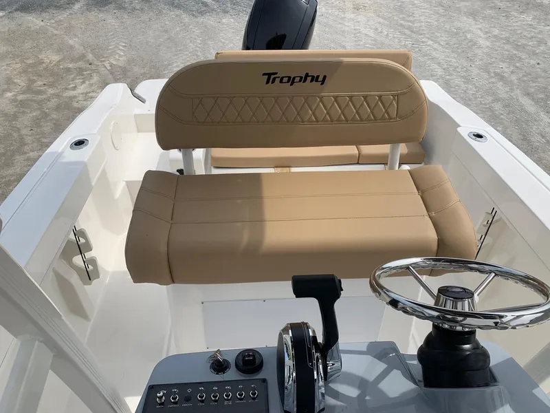 Slide: The Image of 2024 Bayliner Trophy 20 CC boat interior with steering wheel and beige seating. - 11