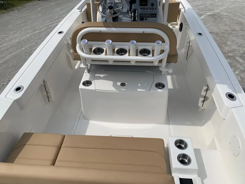 Slide: The Image of 2024 Bayliner Trophy 20 CC boat interior with tan seating and rod holders. - 5