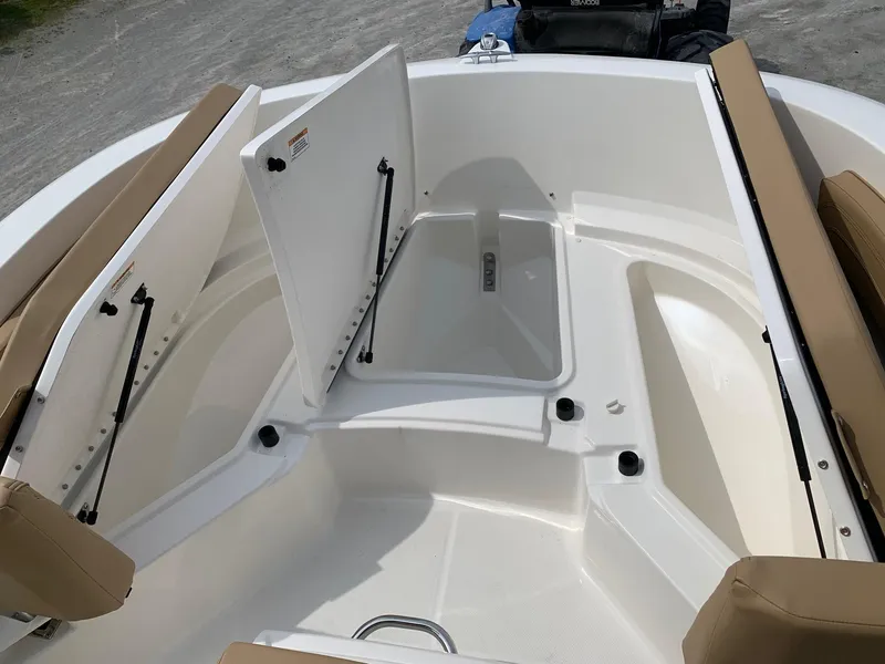 Slide: The Image of 2024 Bayliner Trophy 20 CC boat interior with open storage compartments. - 8