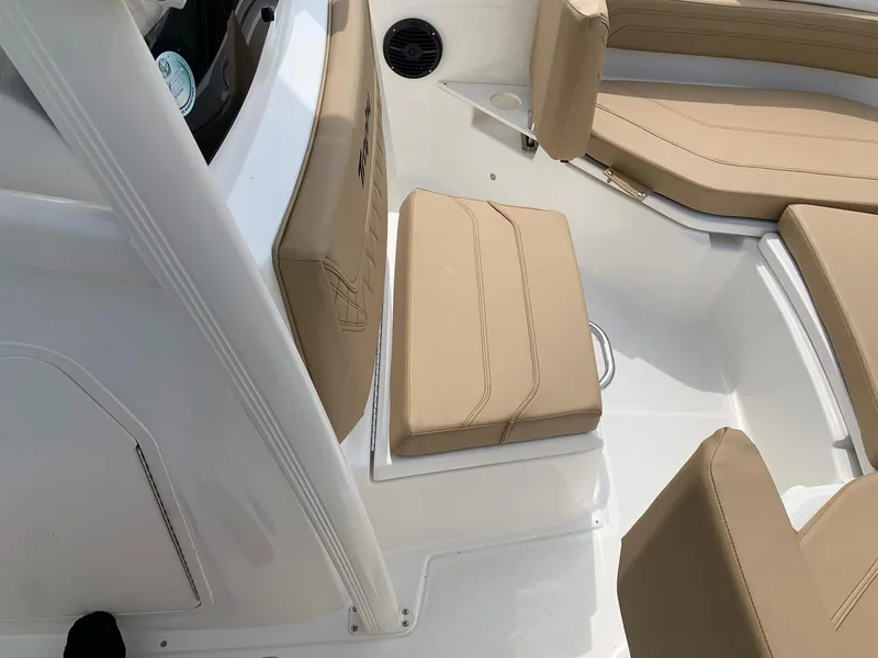 Slide: The Image of 2024 Bayliner Trophy 20 CC boat interior with tan seating and white deck. - 9