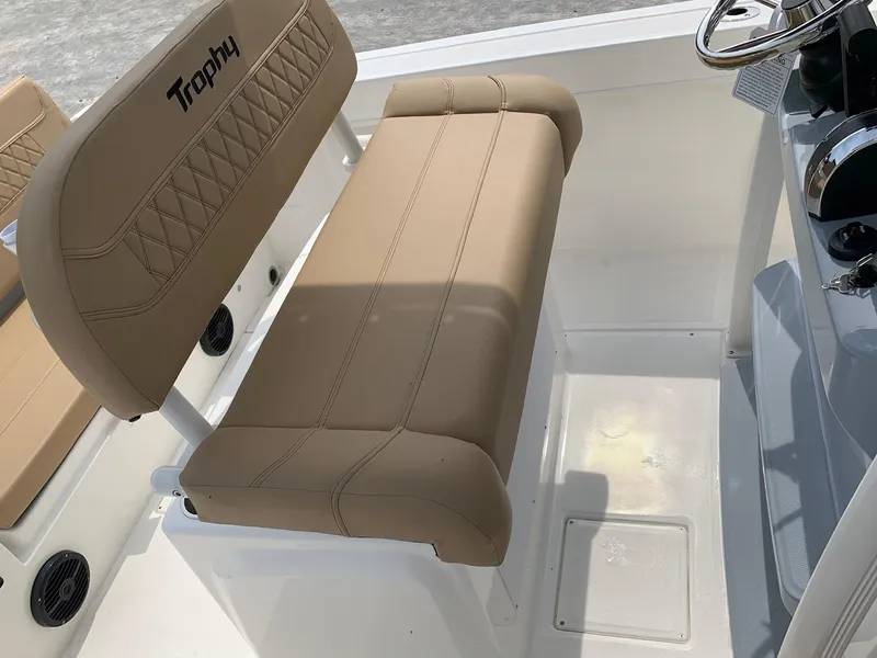 Slide: The Image of 2024 Bayliner Trophy 20 CC boat interior with tan seating and steering console. - 12