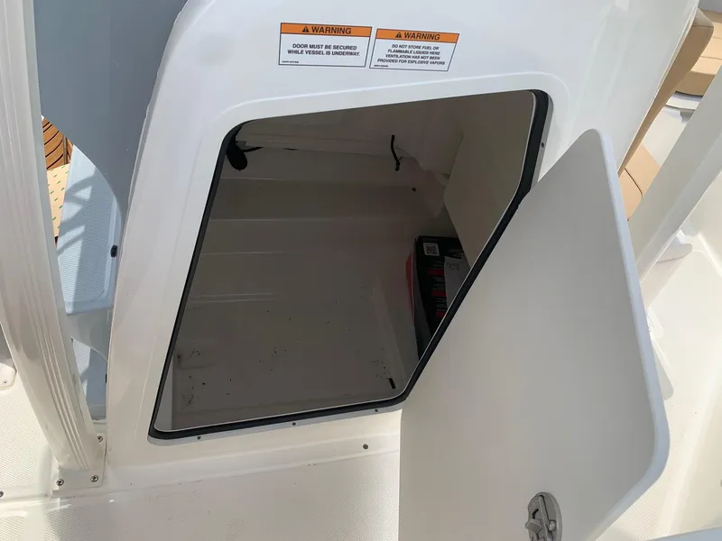 Slide: The Image of 2024 Bayliner Trophy 20 CC storage compartment with open door. - 13