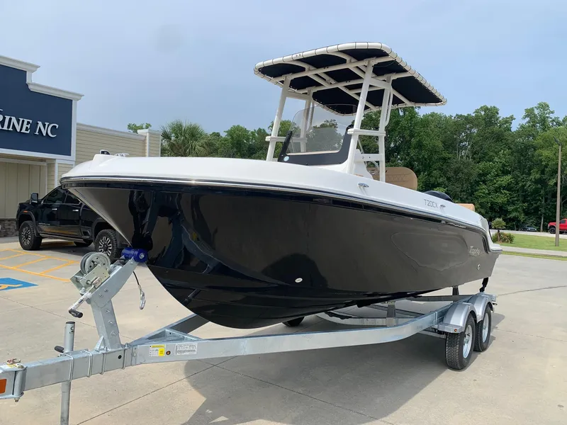 Slide: The Image of 2024 Bayliner Trophy 20 CC boat on a trailer at a dealership. - 1