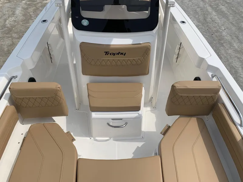 Slide: The Image of 2024 Bayliner Trophy 20 CC boat interior with tan seating and white deck. - 6