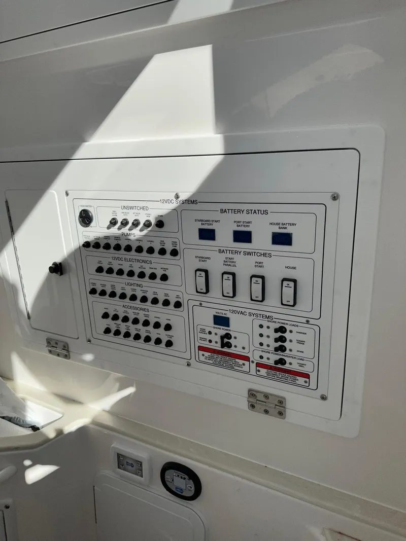 Slide: The Image of Control panel of a 2022 Edgewater 280 CC boat showing battery status and switches. - 12