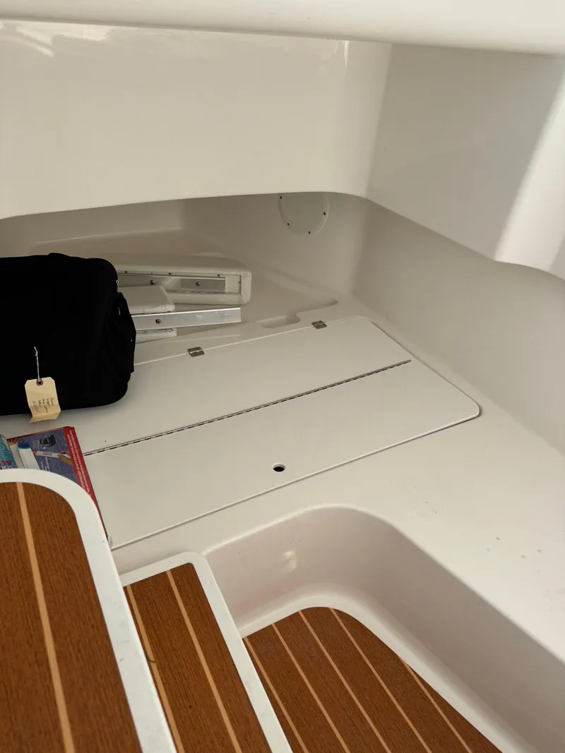Slide: The Image of Interior storage compartment of 2022 Edgewater 280 CC boat with wooden flooring. - 13