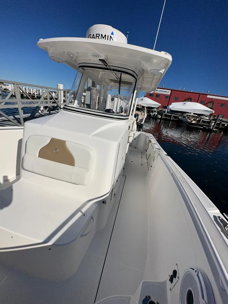 Slide: The Image of 2022 Edgewater 280 CC boat docked at marina with Garmin equipment. - 5