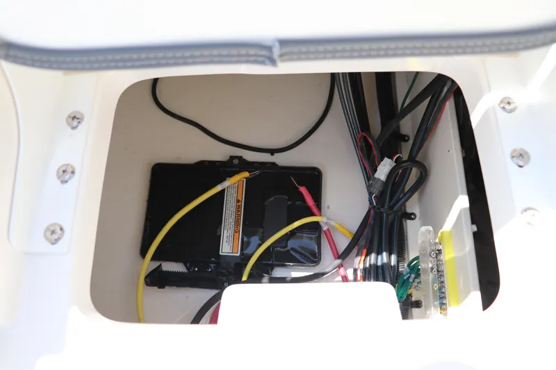 Slide: The Image of 2024 Robalo 206 Cayman boat wiring compartment with cables and battery connections. - 10