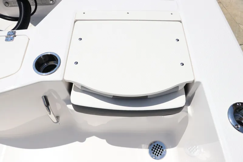 Slide: The Image of 2024 Robalo 206 Cayman boat deck with storage compartment and cup holder. - 13
