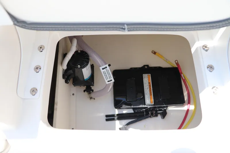 Slide: The Image of 2024 Robalo 206 Cayman boat compartment with battery and wiring. - 15