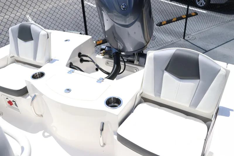 Slide: The Image of 2024 Robalo 206 Cayman boat interior with seating and engine view. - 16