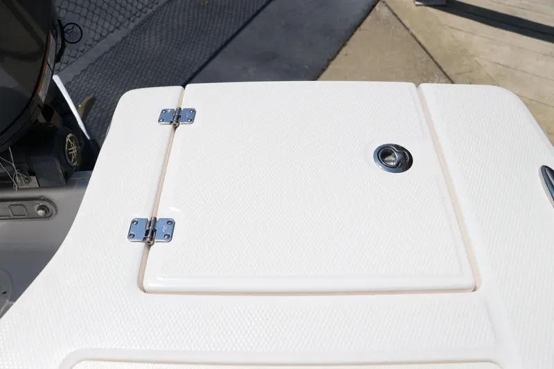 Slide: The Image of 2024 Robalo 206 Cayman boat deck with storage hatch and metal hinges. - 17