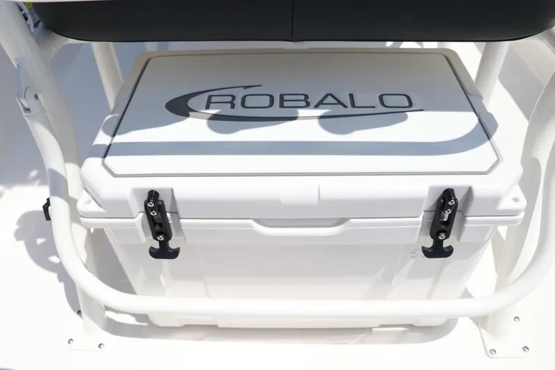Slide: The Image of 2024 Robalo 206 Cayman boat cooler with logo, secured under seating. - 19