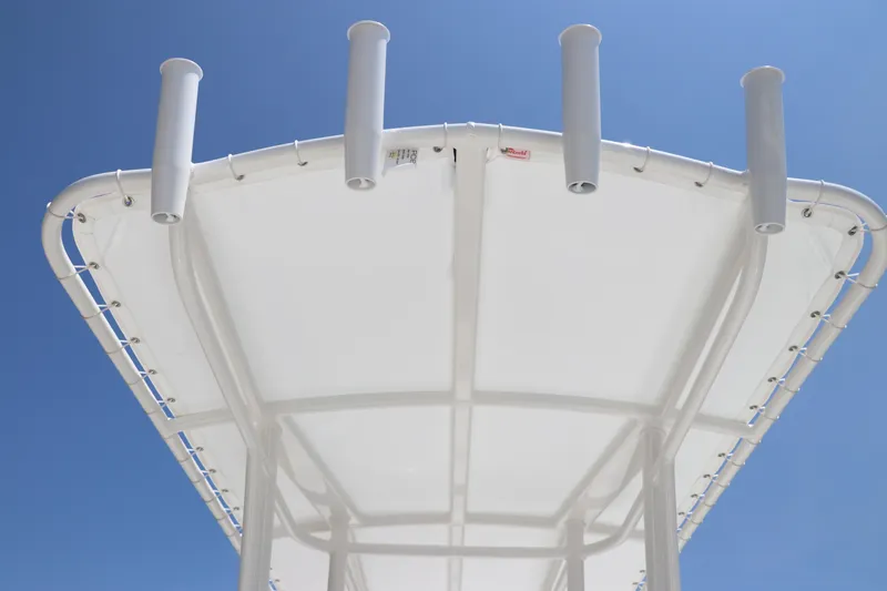 Slide: The Image of T-top of 2024 Robalo 206 Cayman boat against clear blue sky. - 21