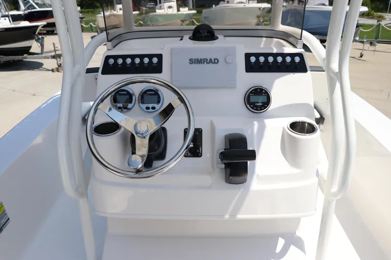 Slide: The Image of 2024 Robalo 206 Cayman boat console with steering wheel and Simrad electronics. - 22