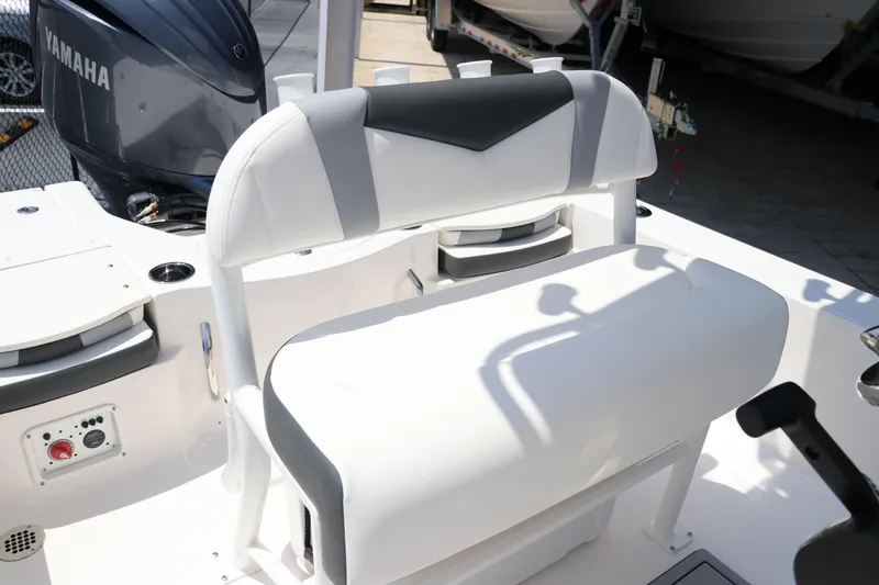Slide: The Image of 2024 Robalo 206 Cayman boat interior with Yamaha engine, featuring a cushioned seat and control panel. - 24