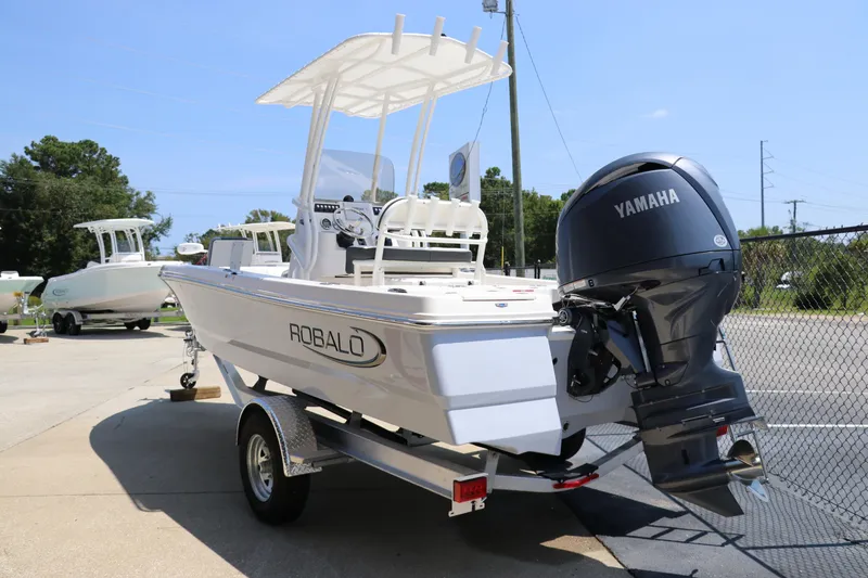 Slide: The Image of 2024 Robalo 206 Cayman boat with Yamaha engine on trailer, outdoor setting. - 3