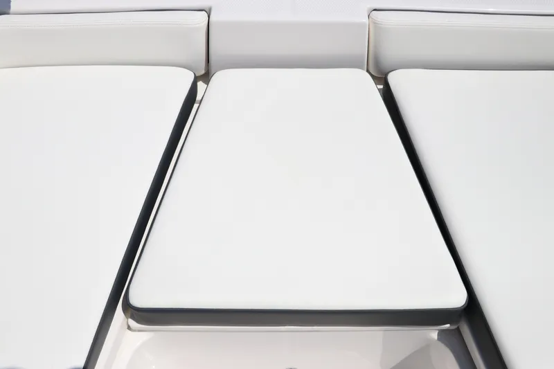 Slide: The Image of 2024 Robalo 206 Cayman boat seating, featuring white cushioned upholstery. - 33