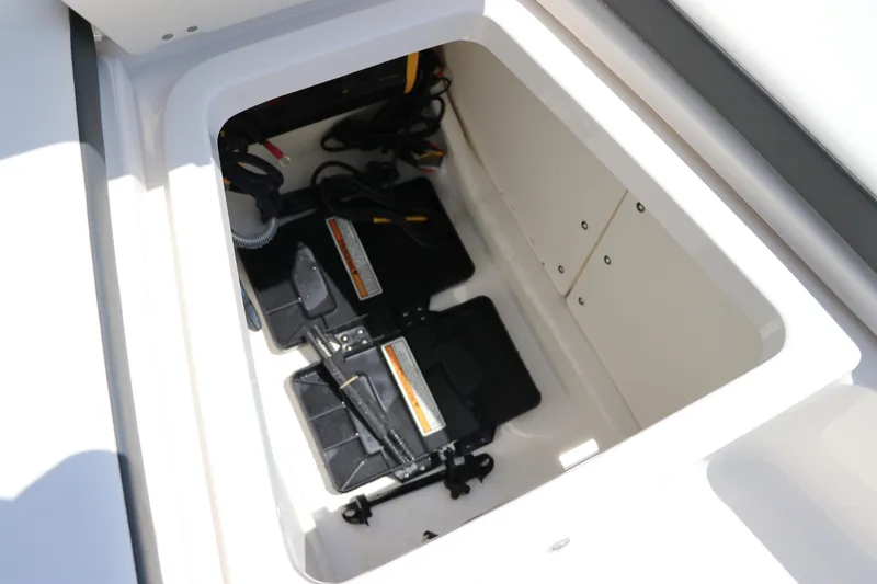 Slide: The Image of 2024 Robalo 206 Cayman boat battery compartment with dual batteries and wiring. - 34