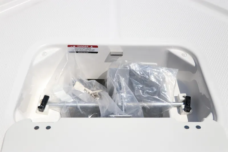 Slide: The Image of 2024 Robalo 206 Cayman storage compartment with packaged accessories. - 36