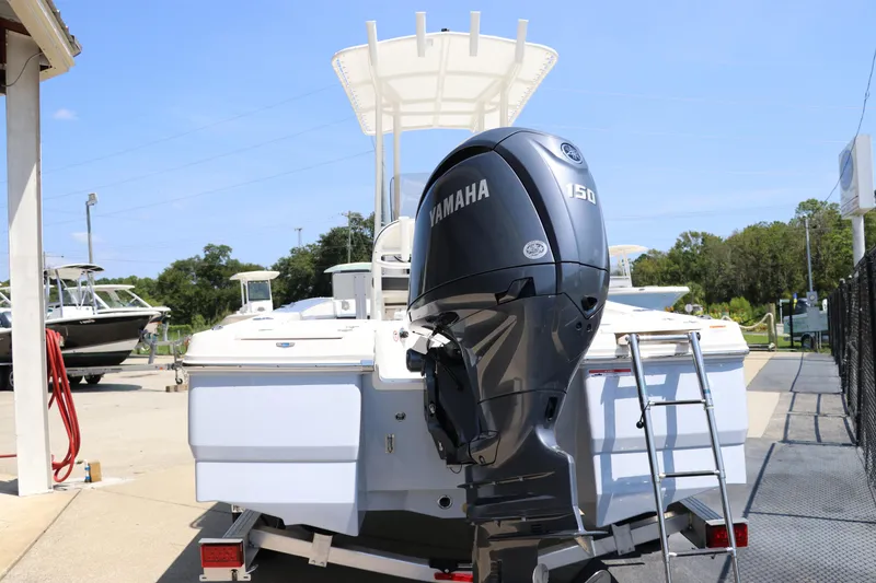 Slide: The Image of 2024 Robalo 206 Cayman boat with Yamaha 150 engine, parked outdoors. - 4