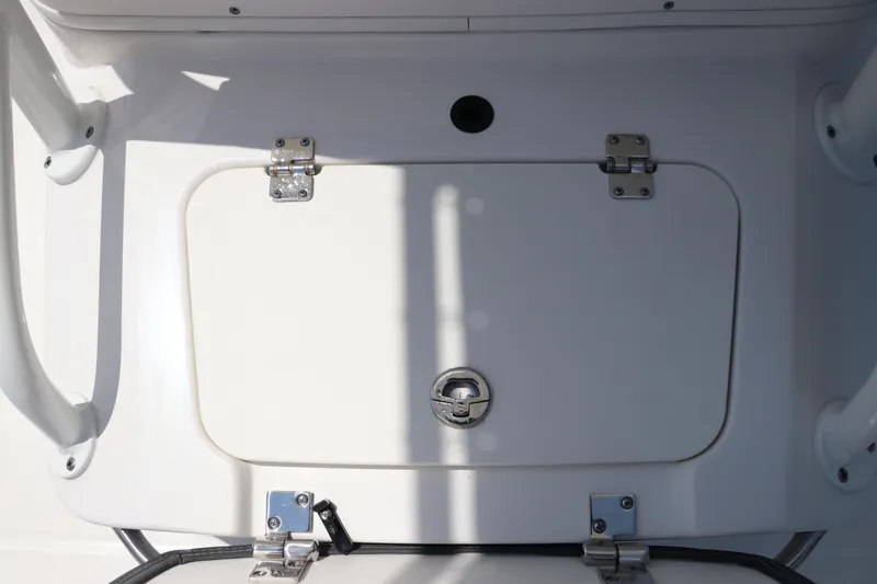 Slide: The Image of 2024 Robalo 206 Cayman boat storage compartment with secure latch and hinges. - 40