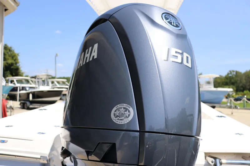 Slide: The Image of 2024 Robalo 206 Cayman with Yamaha 150 outboard motor, docked under clear blue sky. - 5