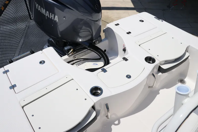 Slide: The Image of 2024 Robalo 206 Cayman boat deck with Yamaha engine, featuring storage compartments and cup holders. - 7