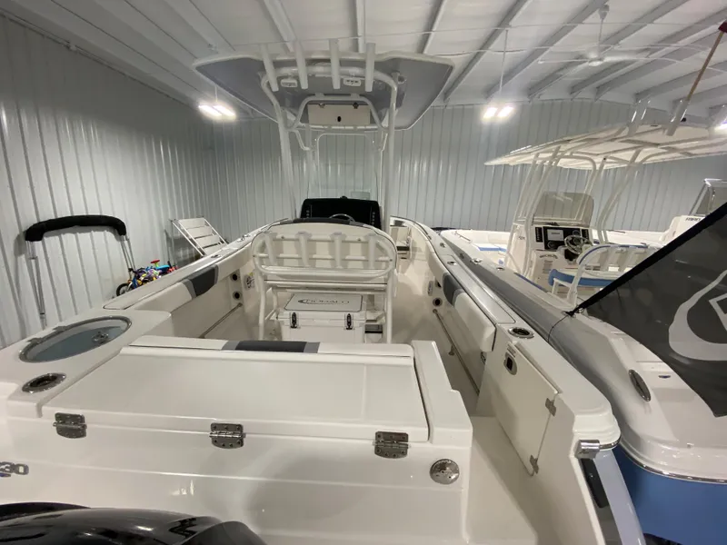 Slide: The Image of 2024 Robalo R230 Center Console boat interior in showroom. - 3