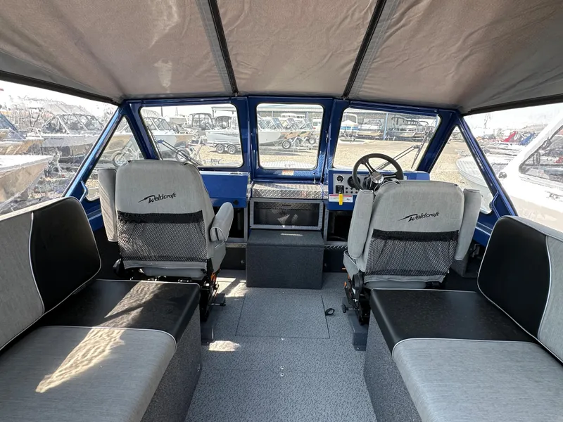 Slide: The Image of Interior of 2024 Weldcraft 220 Maverick boat with seating and steering console. - 3