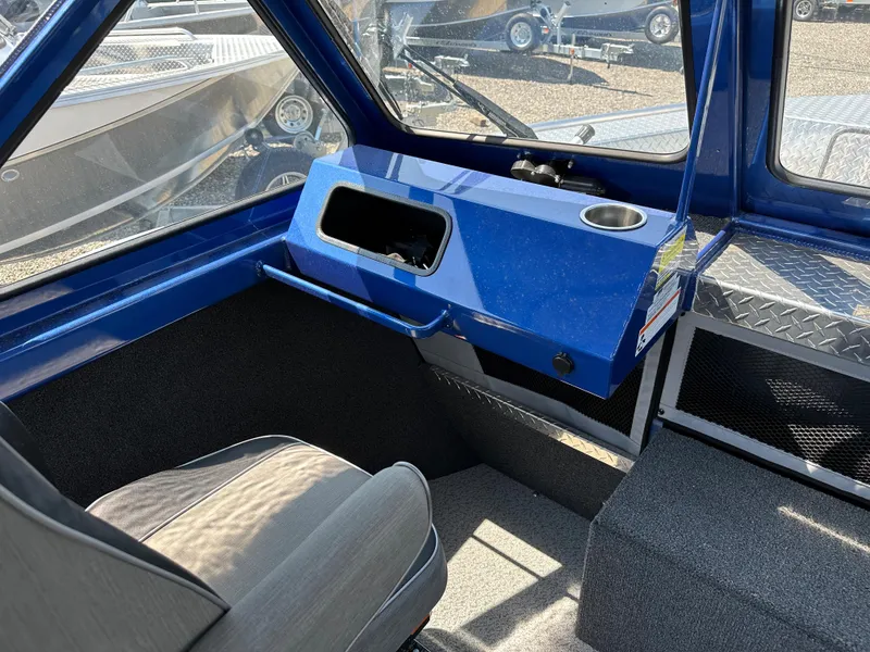 Slide: The Image of 2024 Weldcraft 220 Maverick boat interior with blue dashboard and gray seating. - 5
