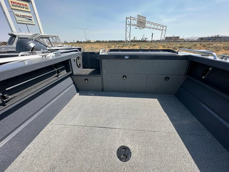 Slide: The Image of 2024 Weldcraft 220 Maverick boat interior with spacious deck and storage compartments. - 7
