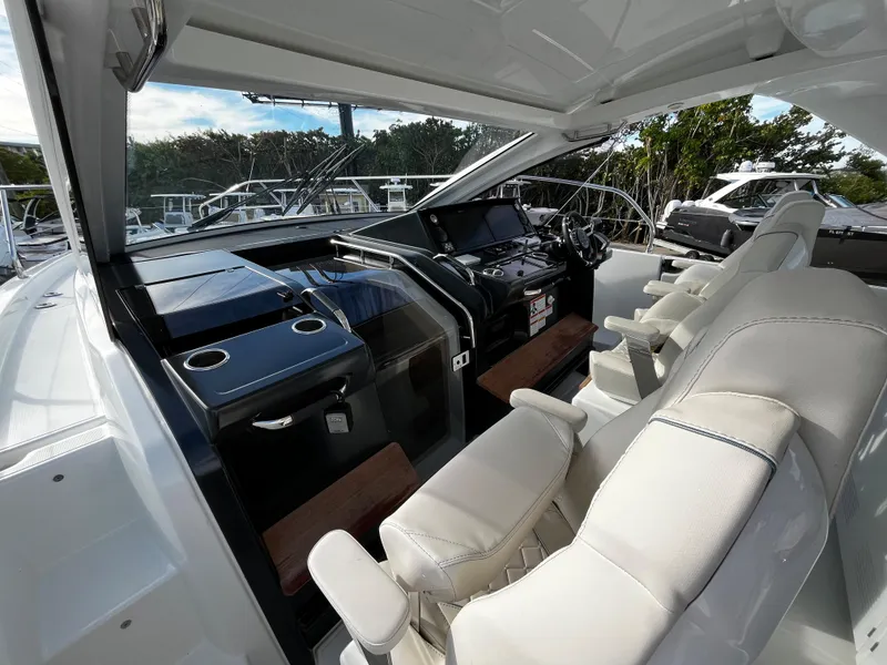 Slide: The Image of 2024 Jeanneau DB/43 OB boat cockpit with modern controls and white seating. - 11