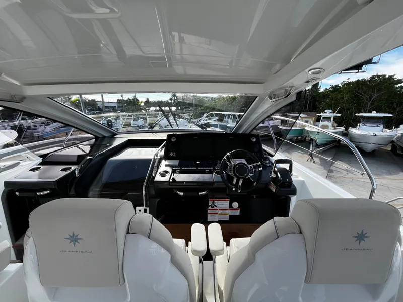 Slide: The Image of 2024 Jeanneau DB/43 OB boat cockpit with dual seats and modern dashboard. - 12