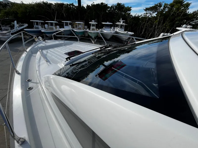 Slide: The Image of 2024 Jeanneau DB/43 OB boat deck and windshield in marina. - 15