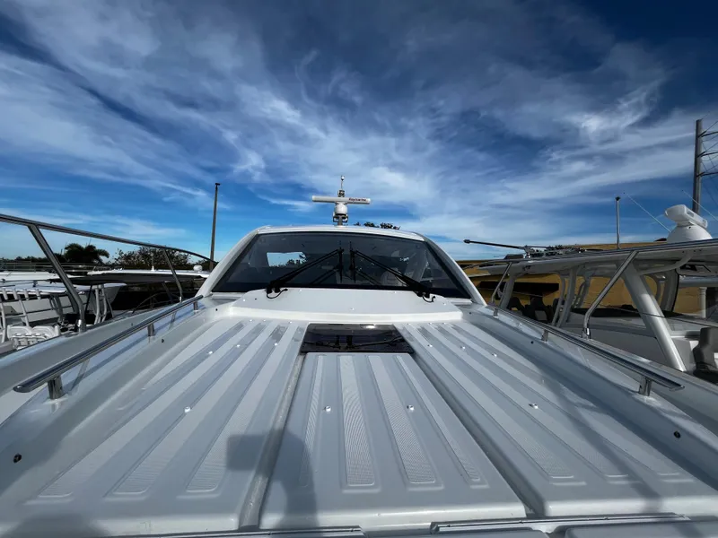 Slide: The Image of 2024 Jeanneau DB/43 OB boat under a clear blue sky. - 18
